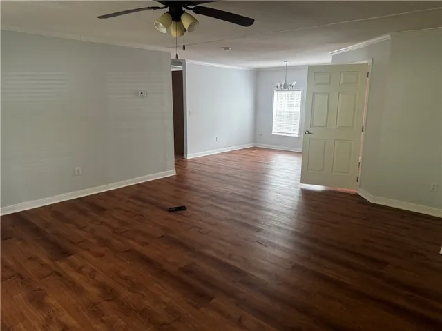 This generous living area features warm wood flooring and ample natural light.