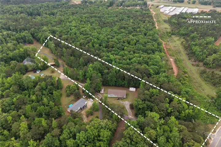 This elevated view captures the expansive, verdant surroundings of this serene rural property.