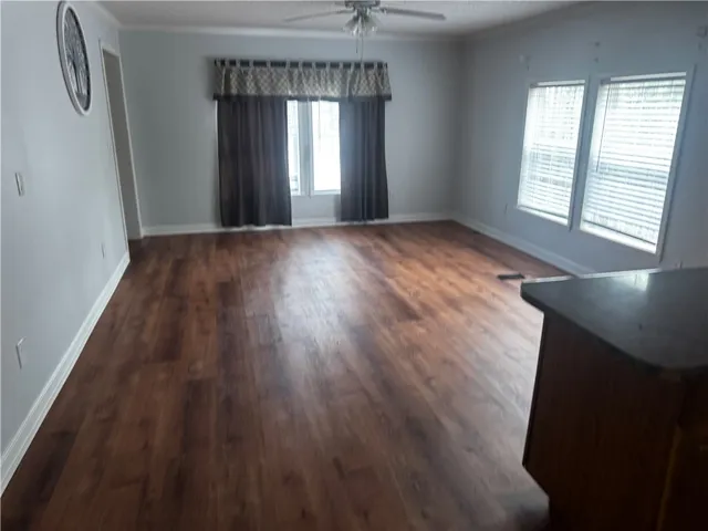 This living space offers resilient flooring and generous window views, creating an inviting atmosphere.