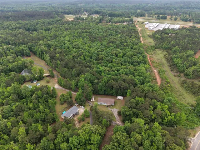 Discover a tranquil rural setting with vast wooded acreage, offering privacy and natural beauty.