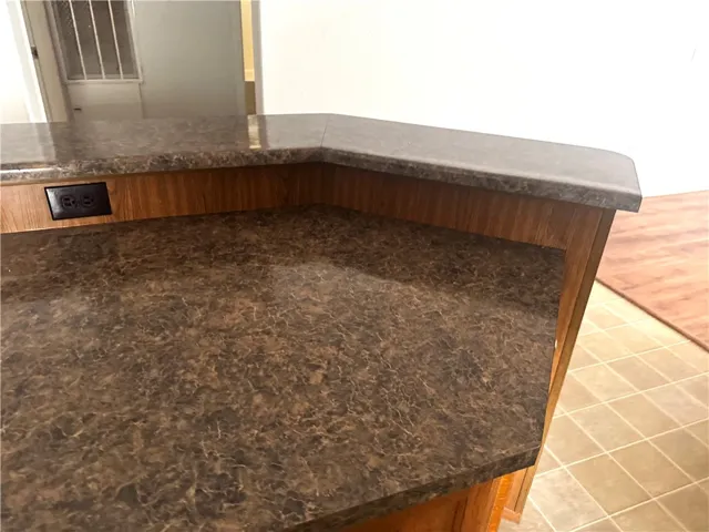 This functional kitchen island features durable countertop surfaces.
