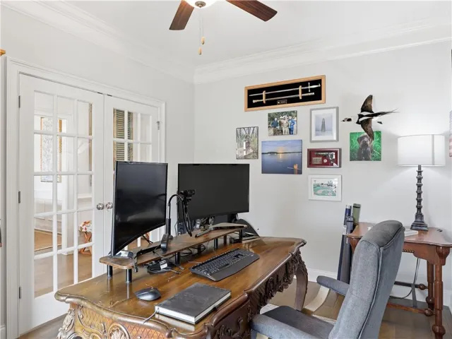 French doors open into a bright home office, perfect for focused work or creative pursuits.