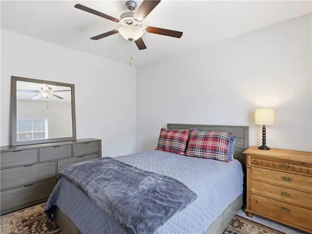 A comforting bedroom offering a tranquil retreat with ample space and overhead lighting.