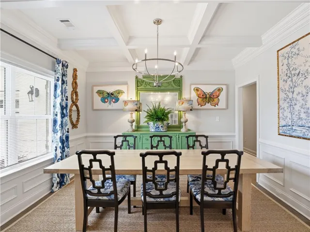 Ornate millwork and a distinct coffered ceiling define this elegant dining space.