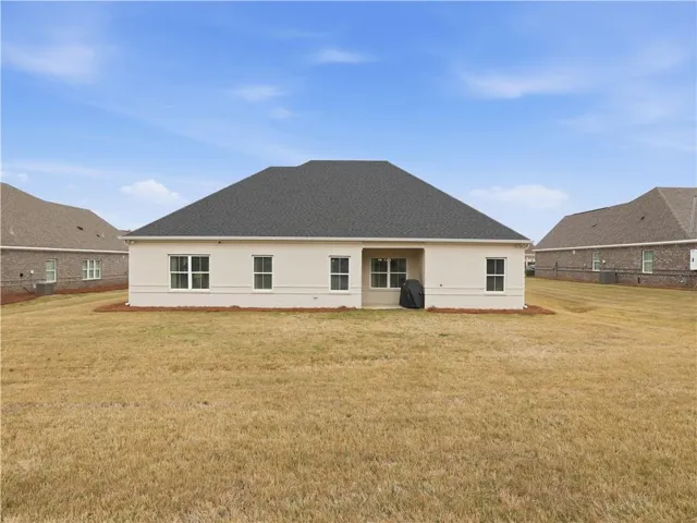 An inviting exterior with a well-maintained lawn and classic architecture awaits.