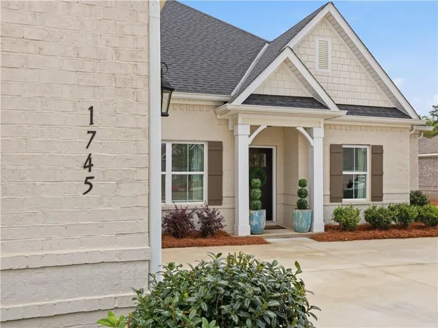 Welcome to this charming residence featuring a classic brick facade, inviting entry, and attractive landscaping.