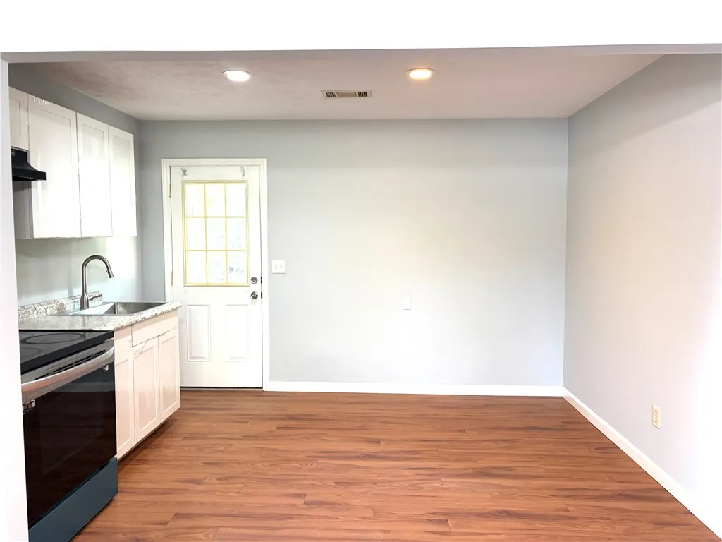 This functional kitchen provides a practical layout for daily culinary tasks and ample space for dining.