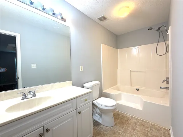 Functional full bathroom with combined shower and tub offers everyday convenience.
