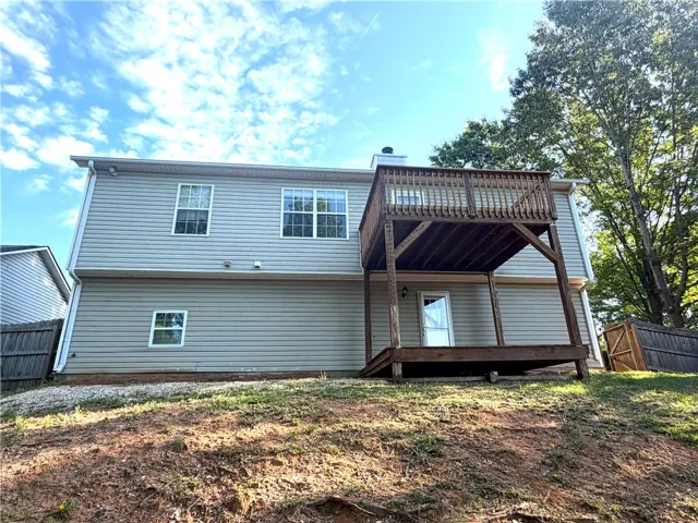 Rear facade reveals a two-story deck, offering elevated outdoor living and ground-level access.