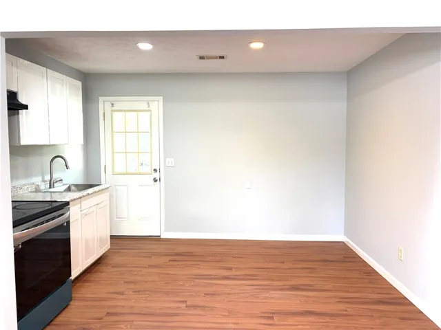 This functional kitchen provides a practical layout for daily culinary tasks and ample space for dining.