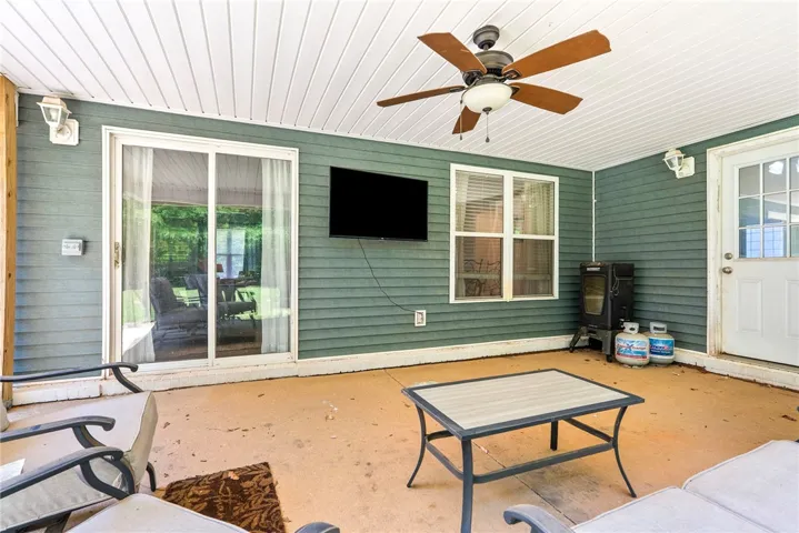 Enjoy outdoor entertaining on this spacious covered patio, perfect for gatherings and relaxation.