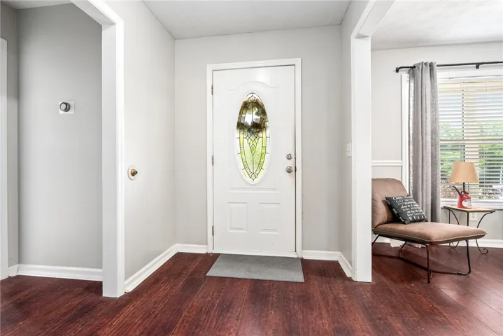 Welcome home to this charming entry with rich hardwood flooring and a decorative glass front door.
