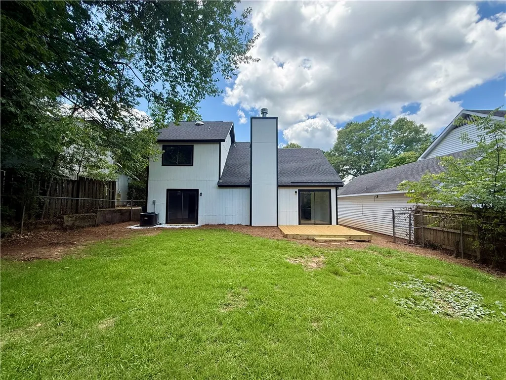 A private yard with a newly built wooden deck offers outdoor leisure opportunities.