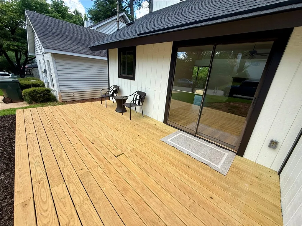 A spacious wooden deck provides ample outdoor living space, perfect for relaxing or entertaining.