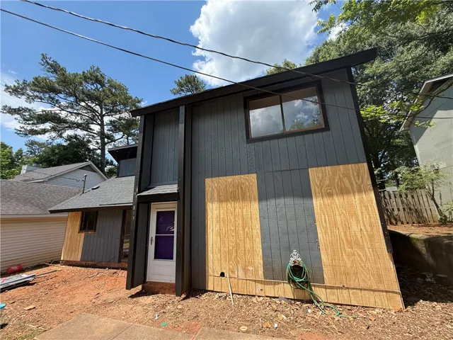 A modern facade with a striking angular design and varied siding materials creates a distinctive visual impact.