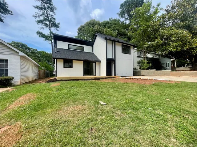 A modern two-story home with a clean aesthetic and an inviting back deck.