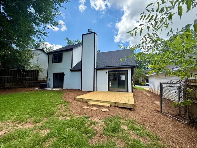 A newly built deck extends from the rear, perfect for outdoor living.