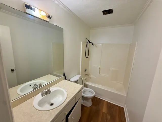 A classic bathroom layout, featuring a functional vanity and a combined shower-tub unit.