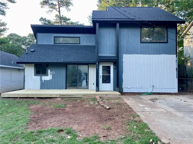 A newly constructed front deck enhances this home's modern facade and outdoor living potential.