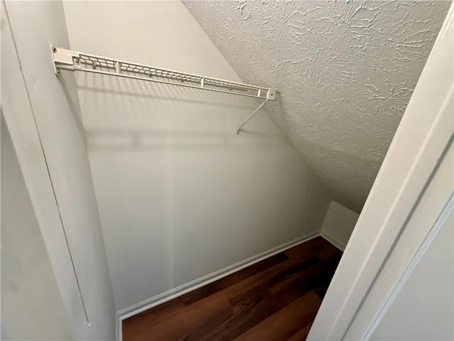 Optimize your storage with this intelligently designed closet featuring ample shelving and durable flooring.