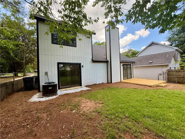A new deck extends from the clean-lined home, offering seamless indoor-outdoor living.