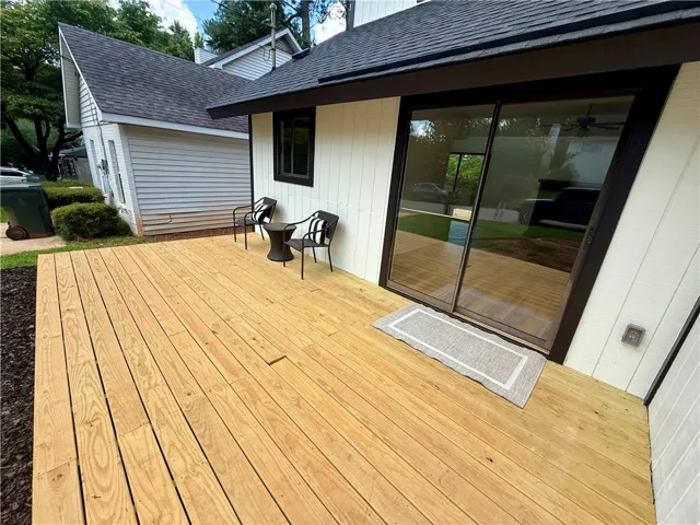 A spacious wooden deck provides ample outdoor living space, perfect for relaxing or entertaining.