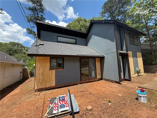 A partially completed exterior with a dark roof and striking angular lines, hinting at modern design.