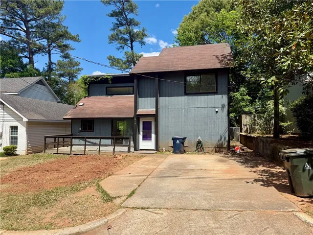 A split-level residence with a welcoming front entrance and an attached deck offers versatile living spaces.