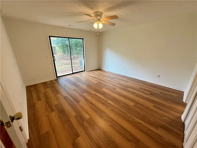 A naturally illuminated room with durable plank flooring, perfect for versatile living.