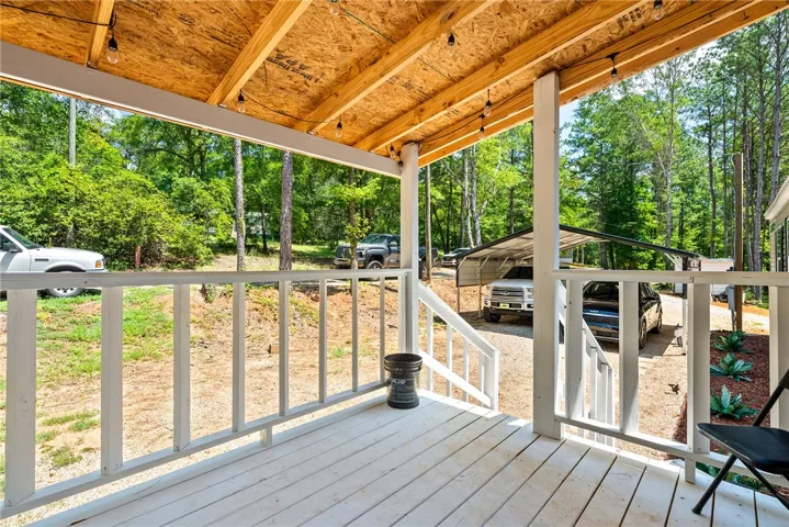 Enjoy the serene outdoor ambiance from this inviting covered patio, perfect for relaxation or entertaining.