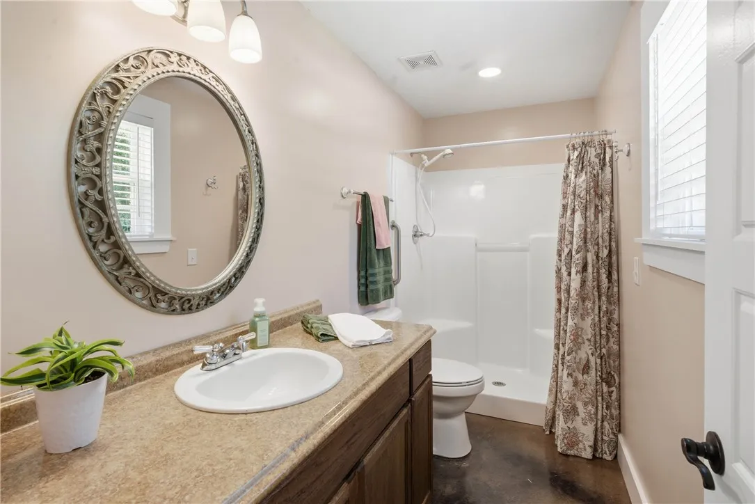 Functional full bathroom featuring a vanity with an integrated sink and a shower with a privacy​​‌​​​​‌​​‌‌​‌‌​​​‌‌​‌​‌​‌​​​‌​​ curtain.