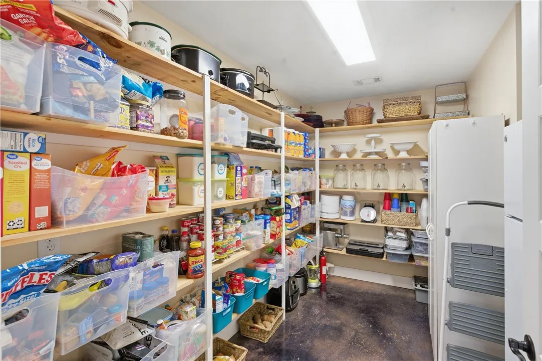 This organized pantry features abundant shelving, providing ample storage for culinary essentials and household items.