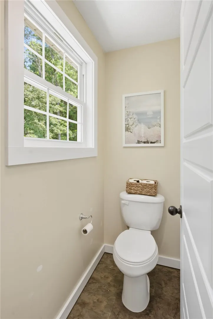 A compact and functional powder room with ample natural light.