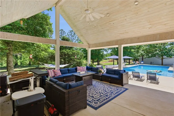 This outdoor oasis features a covered patio with direct access to a refreshing swimming pool.