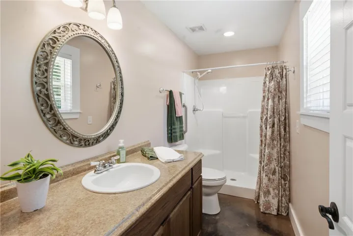 Functional full bathroom featuring a vanity with an integrated sink and a shower with a privacy​​‌​​​​‌​​‌‌​‌‌​​​‌‌​‌​‌​‌​​​‌​​ curtain.