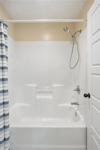 A well-appointed, clean bathroom features a bathtub and shower combination.
