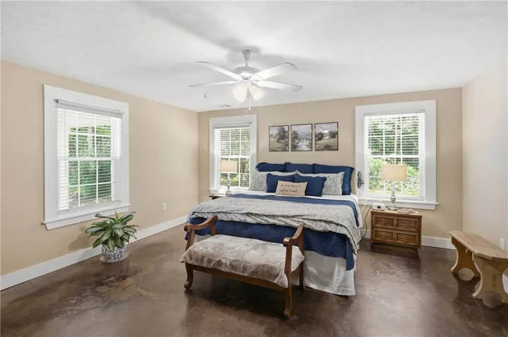 This bedroom offers ample natural light and a relaxed atmosphere for peaceful rest.