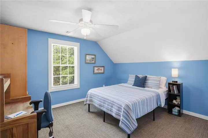 This cozy bedroom features a bright window and practical carpet flooring.