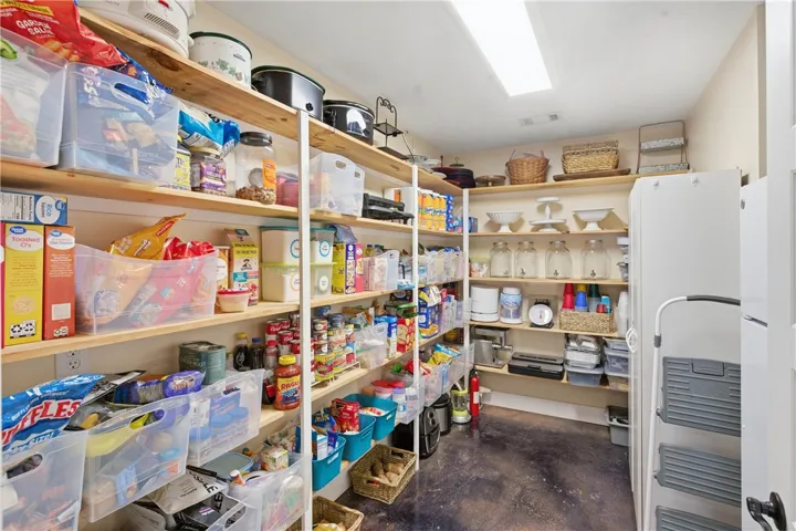This organized pantry features abundant shelving, providing ample storage for culinary essentials and household items.