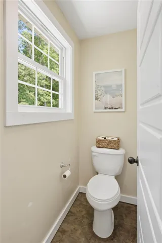 A compact and functional powder room with ample natural light.