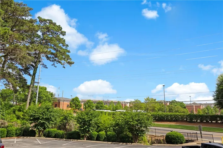 Green landscaping surrounds this property, offering verdant views of the neighborhood and parking.