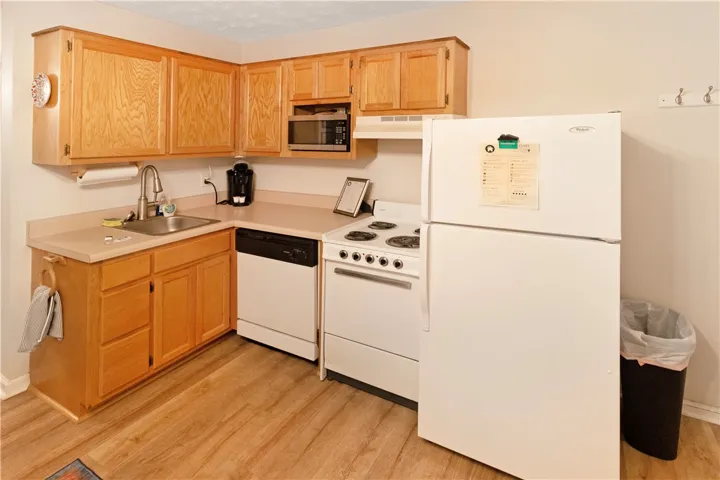 A well-appointed kitchen features ample cabinetry and essential appliances for daily living.