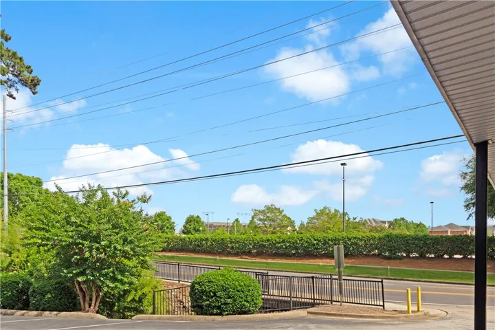 Vistas of the surrounding area unfold, showcasing verdant landscaping and distant structures under an open sky.