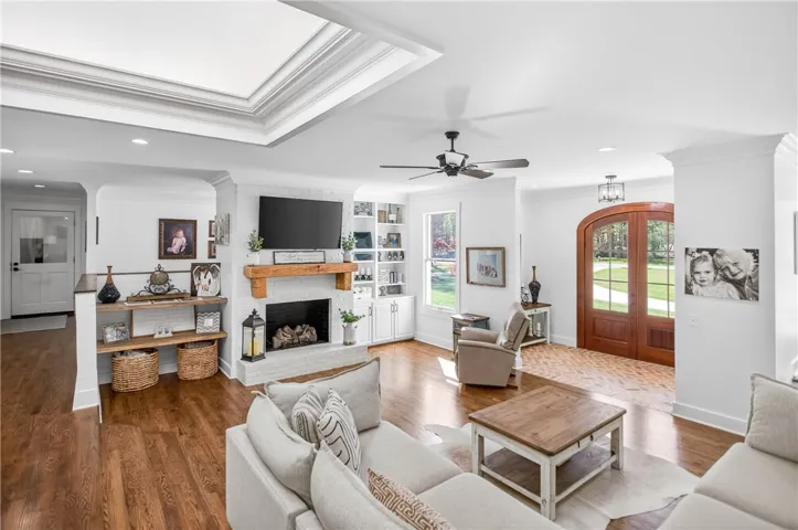 A fireplace takes center stage in this inviting living space with rich hardwood flooring.