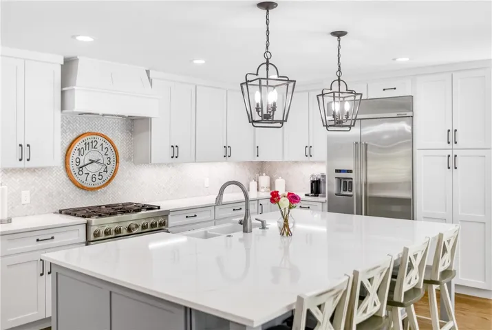 Culinary dreams come alive in this well-appointed kitchen featuring a substantial island and gleaming countertops.