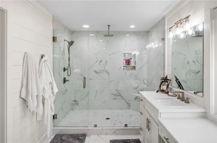 Experience daily luxury in this well-appointed bathroom featuring a spacious walk-in shower and ample vanity space.