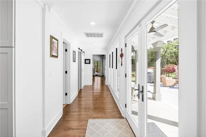 A graceful hallway connects interior living with an inviting outdoor patio.