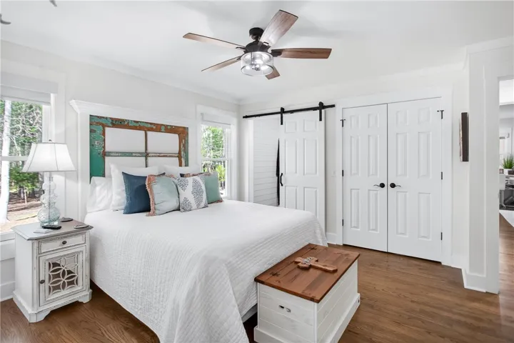 Wood flooring and natural light elevate this welcoming sleeping space.