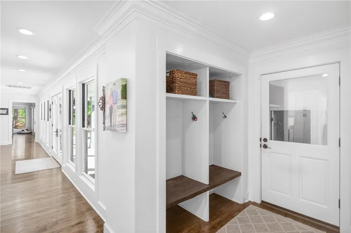 Custom built-ins and rich hardwood floors add charm to this inviting entryway.