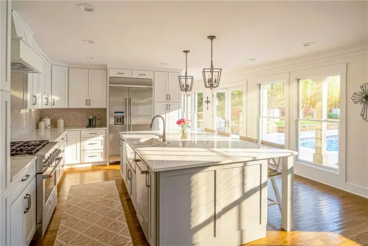 Sun-filled kitchen with a central island and bright views of the outdoors.
